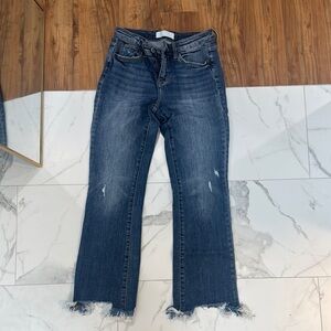 Blue Flare Jeans with Distressed Hem and Subtle Fading